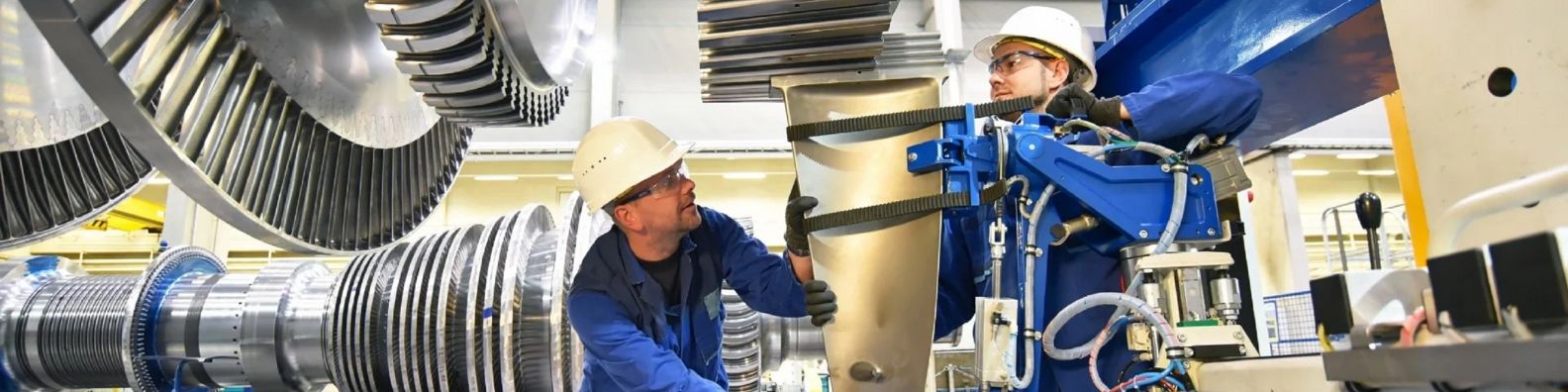skilled labor training and mentorship in Houston Texas two workers in hardhats calibrating a turbine